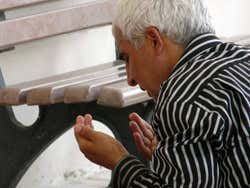 Praying at the entrance to the mosque